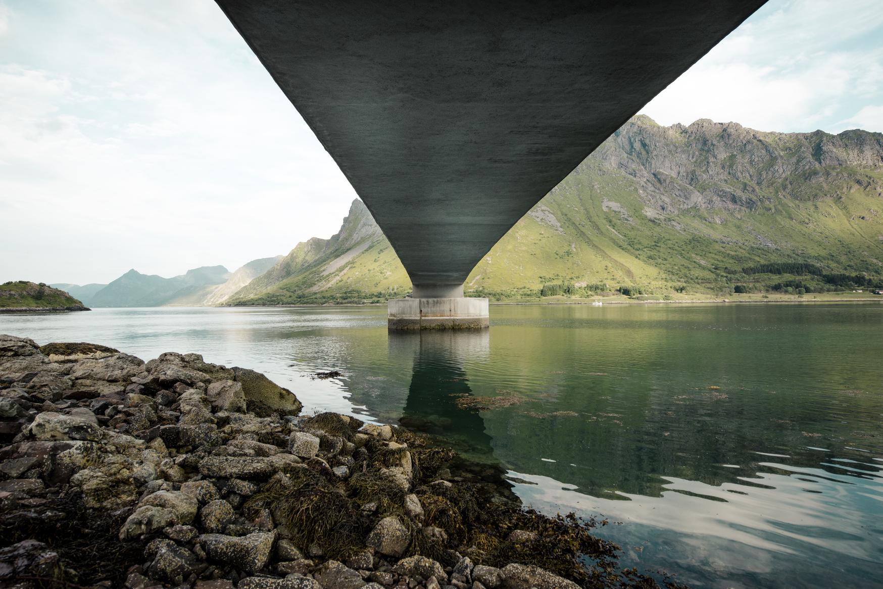 A bridge reflects in the ocean